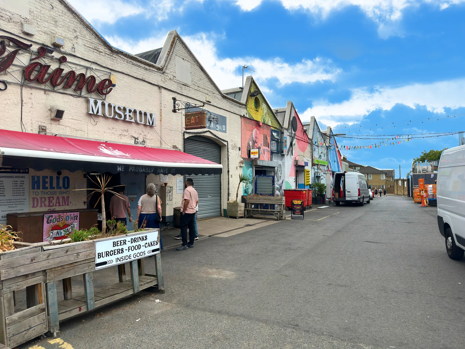 Colourful buildings and signs along the lane at God's Own Junkyard.